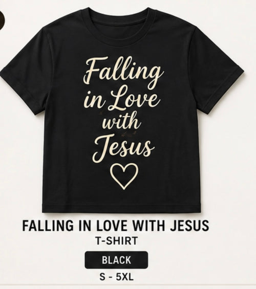 A black short-sleeve T-shirt with the phrase 'Falling in Love with Jesus' and a heart outline printed in beige on the front, shown on a light background with text below reading 'FALLING IN LOVE WITH JESUS T-SHIRT', 'BLACK', and 'S - 5XL'.